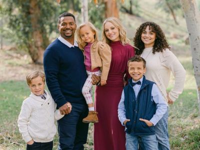 Alfonso Ribeiro is carrying Ava, as his wife Angela, and kids, Anders, Alfonso and Sienna Ribeiro are posing for the picture next to him.